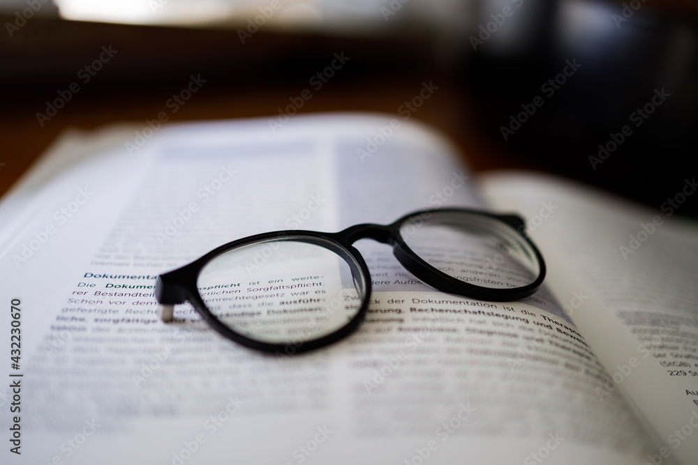 Black framed reading glasses on the book Black framed reading glasses on the book