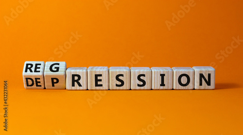 Depression or regression symbol. Turned cubes and changed the word 'depression' to 'regression'. Beautiful orange background. Psychological, depression or regression concept. Copy space.