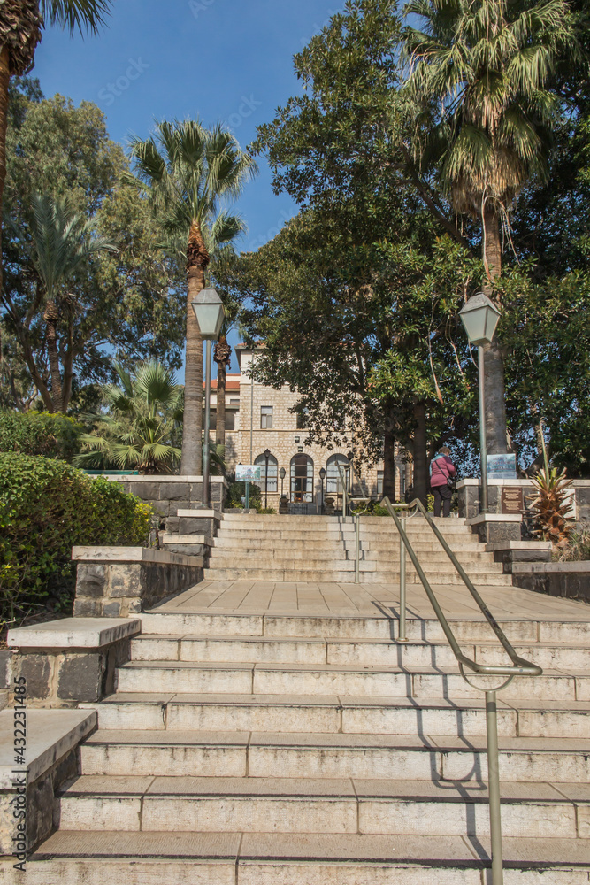 Park with beautiful trees around the church on the Mount of Beatitudes on the Sea of Galilee