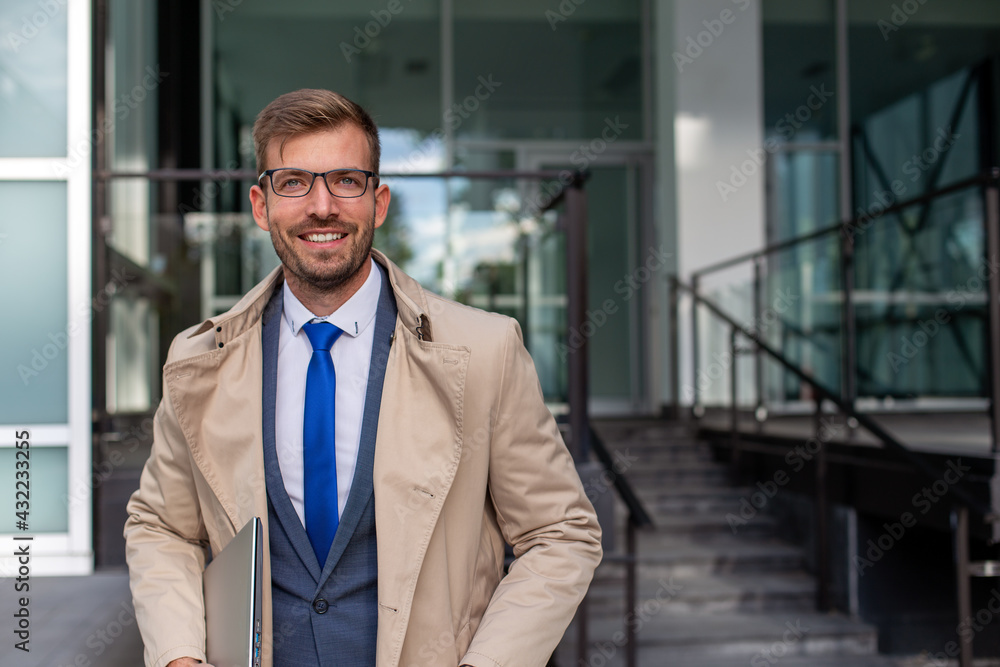 Portrait of a businessman in the front of the modern building. Portrait of a businessman in the front of the modern building.
