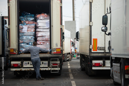 unloading of goods from the truck, checking the imported cargo, a person stands in front of the open body and examines, enhanced customs inspection and export verification
