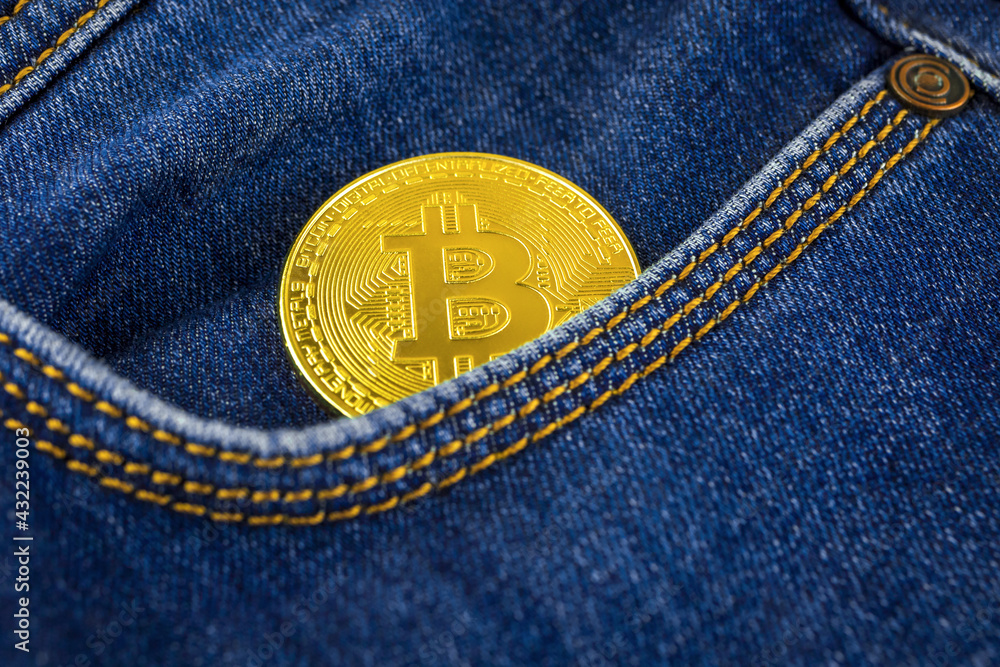 Crypto currency investement and savings concept background with a golden bitcoin in pocket of blue denim jeans close-up view Crypto currency investement and savings concept background with a golden bitcoin in pocket of blue denim jeans close-up view