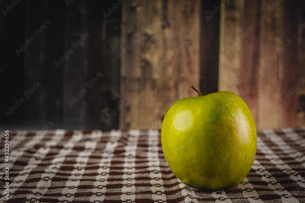 Green apple on rustic wooden background. Green apple on rustic wooden background.
