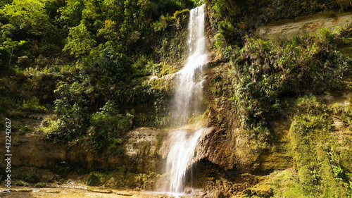 Beautiful waterfall in green forest  top view. Tropical Can-umantad Falls in mountain jungle. Bohol  Philippines. Waterfall in the tropical forest.