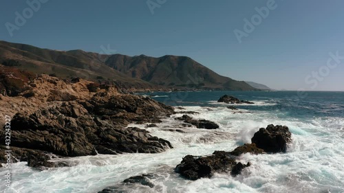 westcoast california at highway one flying over cliffs aerial drone coastline white water waves breaking at shore 4k