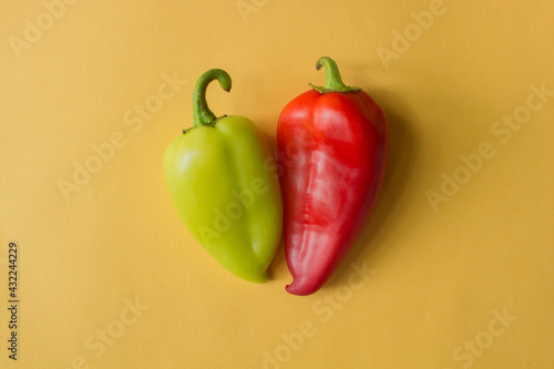 red and green bell peppers on yellow background. High quality photo