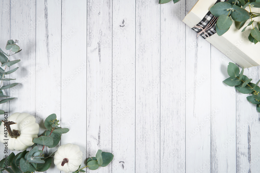 Decorated border background. On-trend farmhouse aesthetic flatlay flatlay with farmhouse style decor, stack of books, and bows on a white wood background. Negative copy space. - obrazy, fototapety, plakaty 