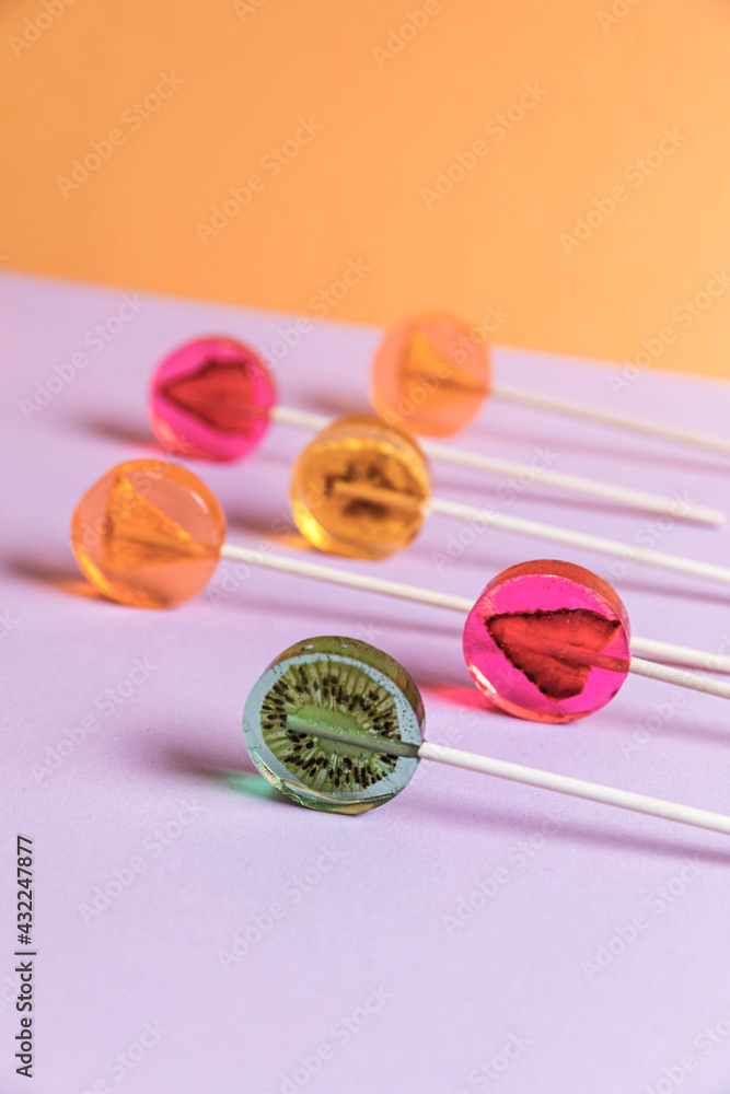 Sugar-free lollipops with dry fruits inside on a lilac background. Healthy sweetness, benefits of natural fruits Sugar-free lollipops with dry fruits inside on a lilac background. Healthy sweetness, benefits of natural fruits
