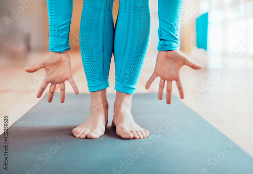 feet and hands in a yoga class on a blurred background. minimalism and purity concept.