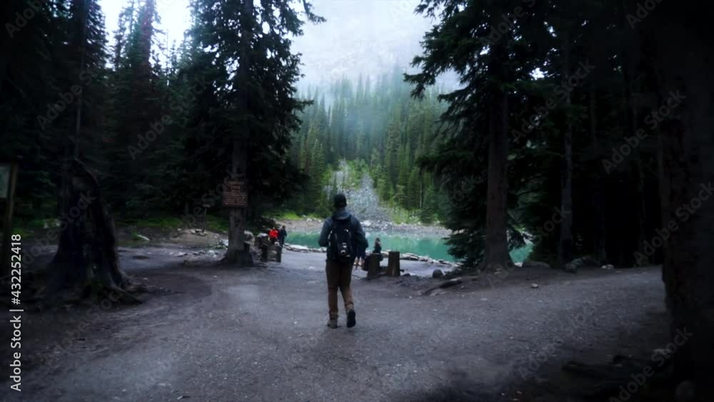 Young guy walking toward misty lake in slow motion. Young guy walking toward misty lake in slow motion.