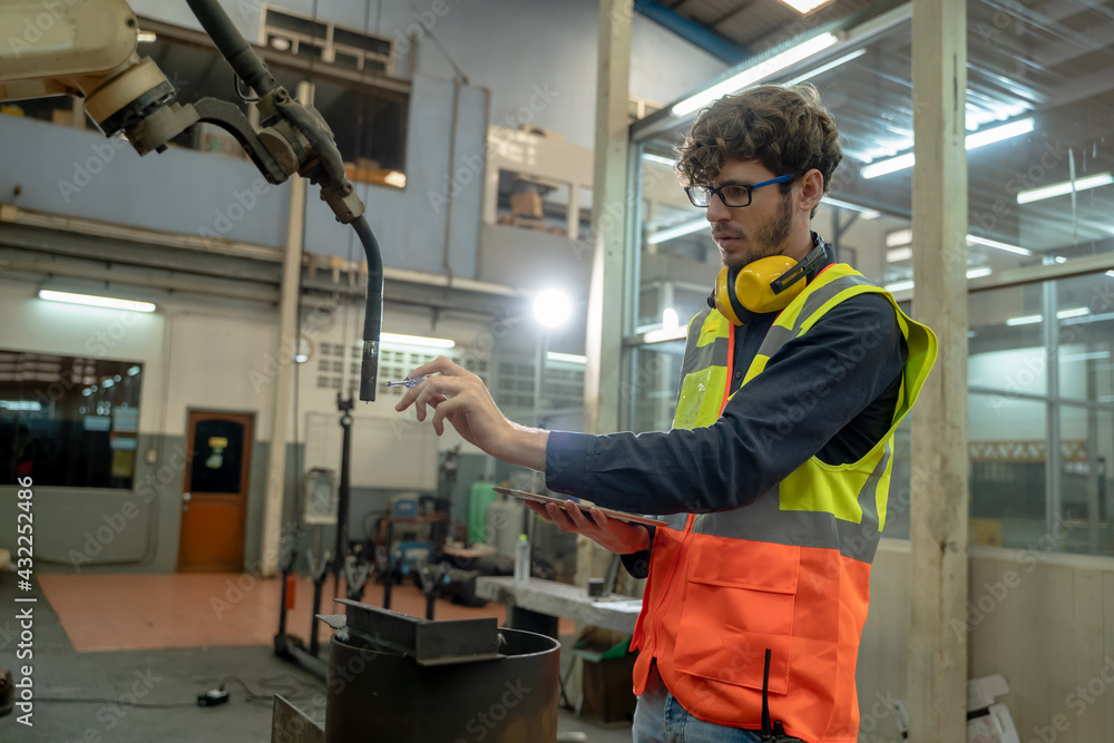 Engineer factory control and checking the robot working in factory workplace. Engineer factory control and checking the robot working in factory workplace.