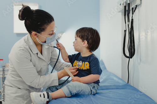 Dr. pediatrician with attending toddler photo