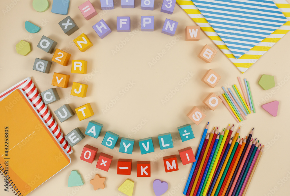 Obraz premium Multicolored wooden fractions, cubes, numbers on wooden table. Trendy puzzle toys. Geometric shapes. Back to school. Educational toys for kindergarten, preschool or daycare. Close up.