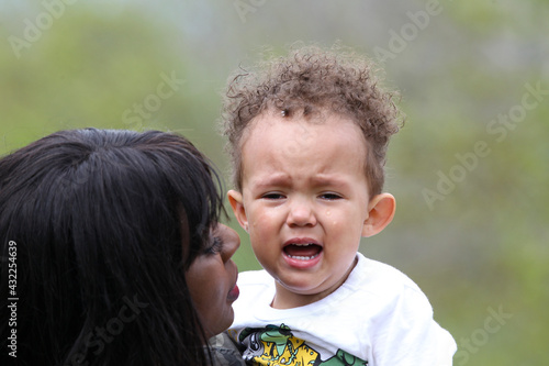 Photography Mom tenderly held crying 2-year-old son with tears on face