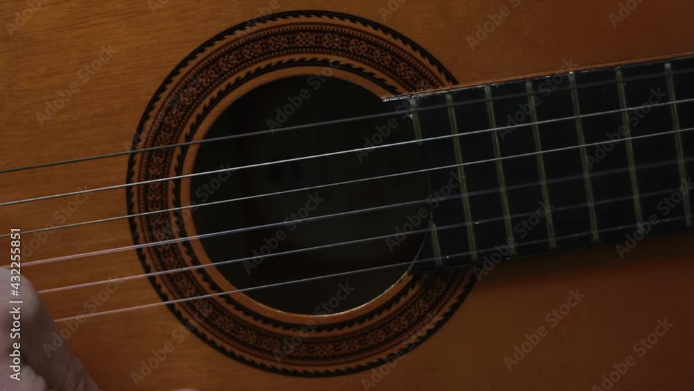 Playing a classic guitar, sound hole view Playing a classic guitar, sound hole view