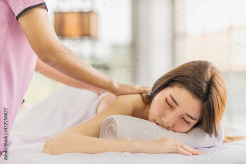 woman having hand massage treatment by massage therapist in spa