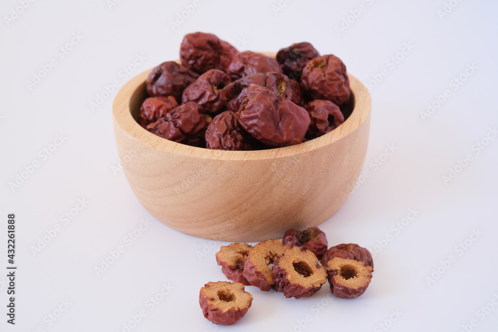 Red dates or red jujubes in wooden bowl isolated on white background. Selected focus.
Red dates or red jujubes in wooden bowl isolated on white background. Selected focus.