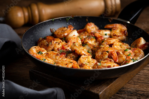 Delicious grilled prawns on wooden background.