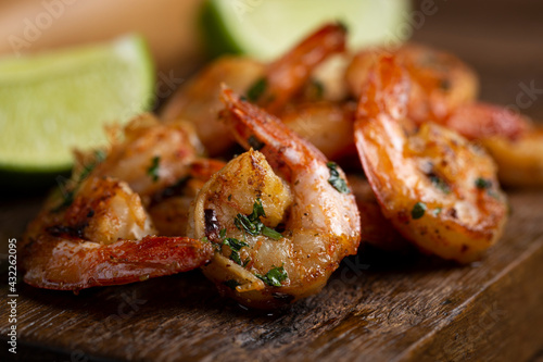 Delicious grilled prawns on wooden background.