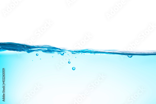 Water waves cause bubbles and splatter in clear blue water.