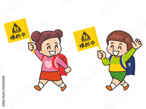 横断中の旗を持って歩く小学生