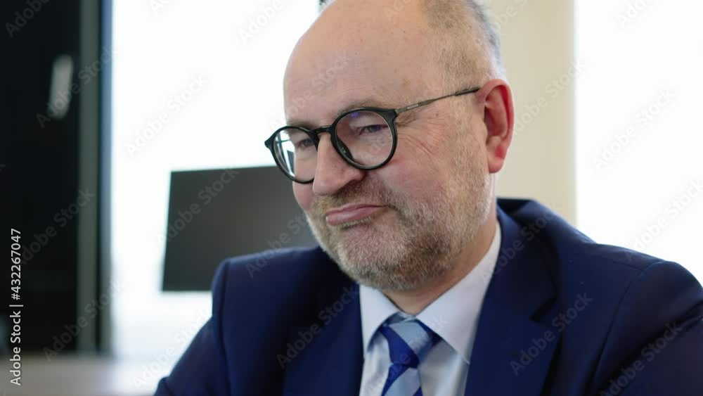 Financial advisor in suit smilingly reacts to questions during a consultation Financial advisor in suit smilingly reacts to questions during a consultation