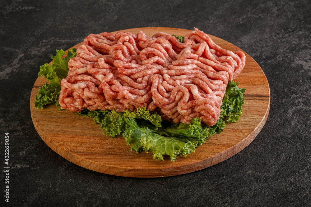 Raw pork minced meat over board Raw pork minced meat over board