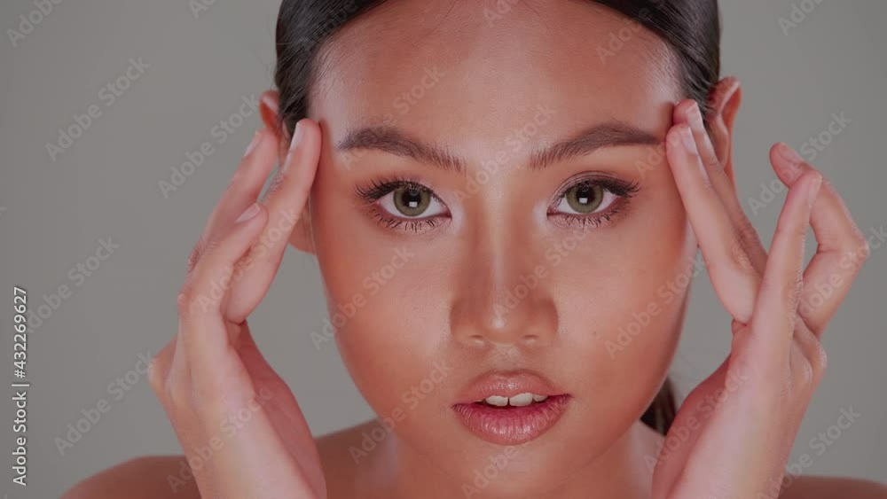 Beautiful face of Asian young woman with natural skin. Portrait of attractive girl with soft make-up and tanned skin. Beautiful face of Asian young woman with natural skin. Portrait of attractive girl with soft make-up and tanned skin.