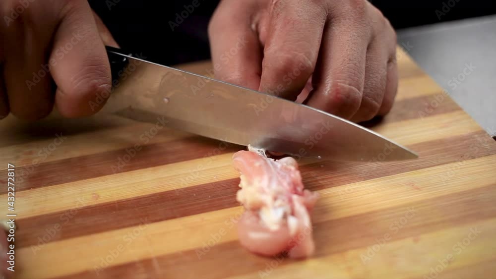 fresh chicken wings cut by chef with a knife to bring a shape of lollipop for preparing delicious Indian food fresh chicken wings cut by chef with a knife to bring a shape of lollipop for preparing delicious Indian food
