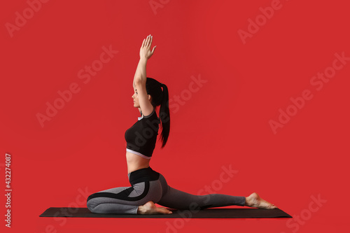 Young woman practicing yoga...