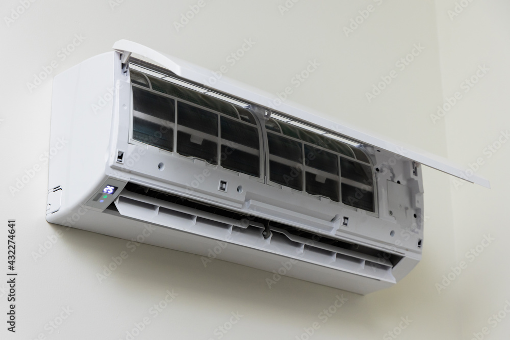 The air conditioner is hung on the wall of the house. Open the front cover to wait for maintenance. The air conditioner is hung on the wall of the house. Open the front cover to wait for maintenance.