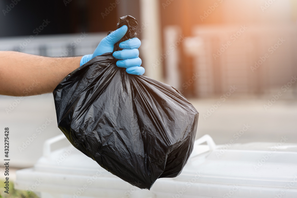 The young man separated the dangerous waste into a large black bag and