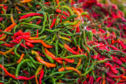 Close-up green, orange and red vegetable for background, green pepper texture. Green chili peppers form a natural shape. Fresh raw vegetables