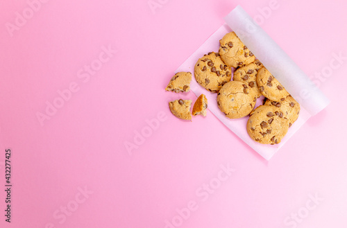 cookies on parchment paper on pink background