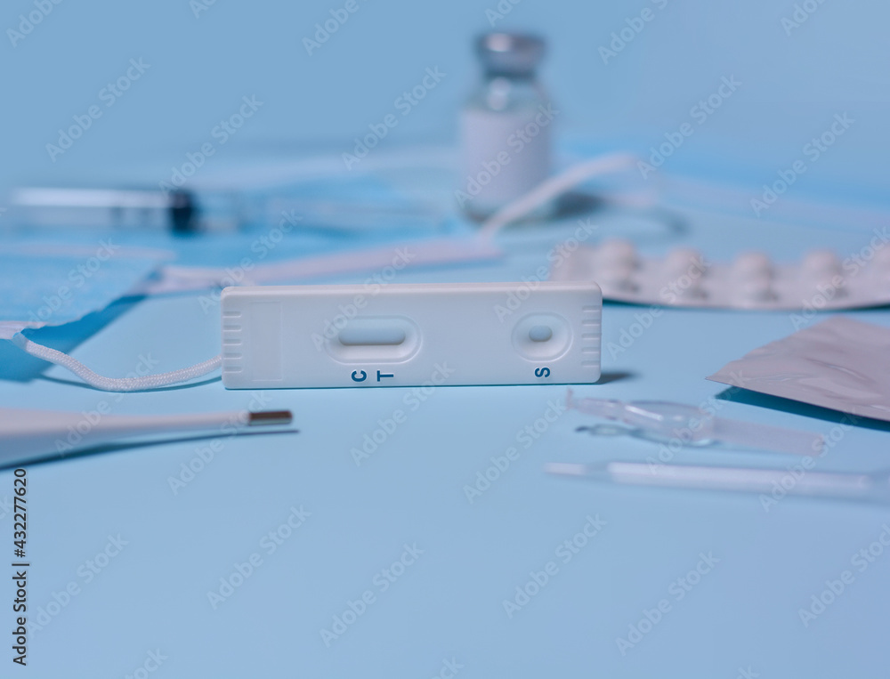 Express COVID-19 test,Schnelltest, medical mask, syringe,thermometer,medicine on a blue background.Diagnosis of coronavirus, Inhibition of disease outbreaks.Copy space Express COVID-19 test,Schnelltest, medical mask, syringe,thermometer,medicine on a blue background.Diagnosis of coronavirus, Inhibition of disease outbreaks.Copy space