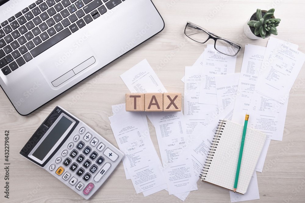 Unrecognizable businessman using calculator on desk office and writing make note with calculate about cost at home office. finance accounting concept. tax , shopping, cost management Unrecognizable businessman using calculator on desk office and writing make note with calculate about cost at home office. finance accounting concept. tax , shopping, cost management