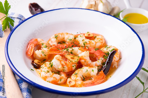 Gambas al ajillo. Shrimp Scampi. Traditional Spanish tapa with prawns cooked in oil with garlic and chilli.
