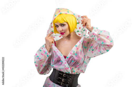 Hipster girl in in yellow wig isolated on white background. Close up portrait of cheerful woman wearing in raincoat
