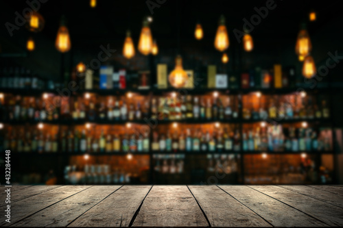 Wooden table with Blurred liquor bar background 