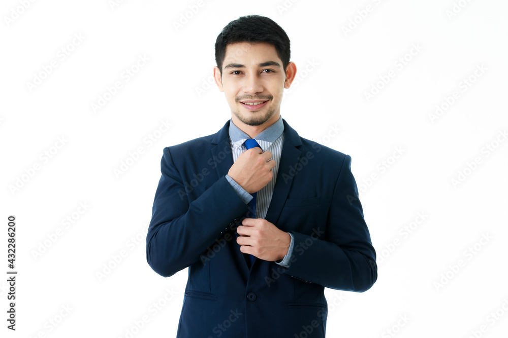 Smiling handsome young Asian businessman adjust his necktie on isolated white background. Studio half body portrait, business and success concept. Smiling handsome young Asian businessman adjust his necktie on isolated white background. Studio half body portrait, business and success concept.