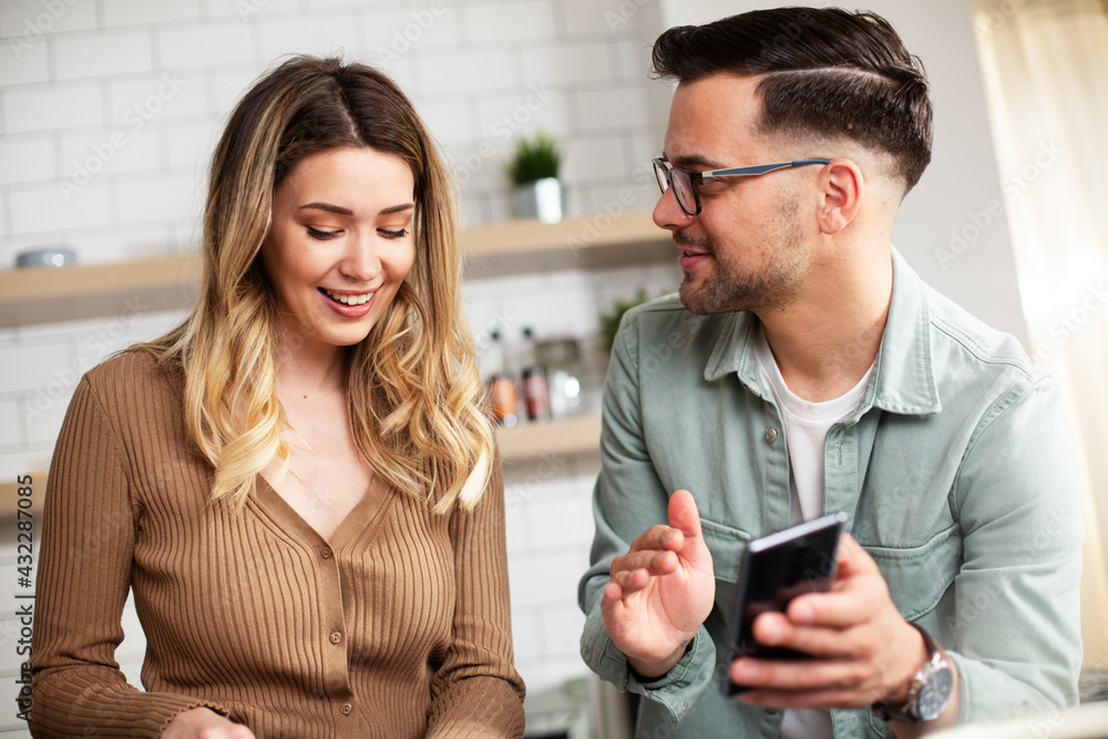 Happy smiling couple cooking together. Boyfriend and girlfriend having video call while preparing delicious food.. Happy smiling couple cooking together. Boyfriend and girlfriend having video call while preparing delicious food..