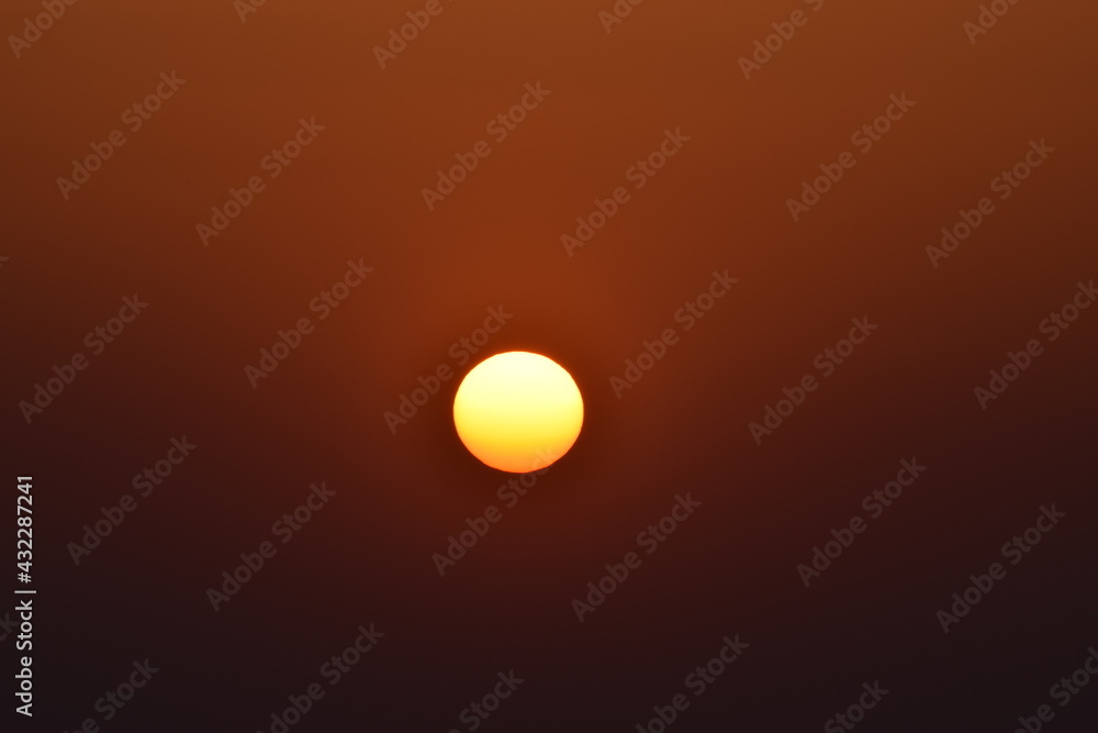 Orange big sun isolated on orange background. Sunset, Selective focus, Selective Focus On Subject, Background Blur