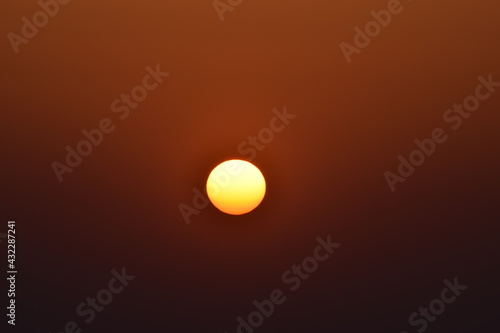Orange big sun isolated on orange background. Sunset, Selective focus, Selective Focus On Subject, Background Blur