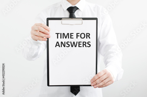 Man holding tablet with text time for answers on light background, business concept