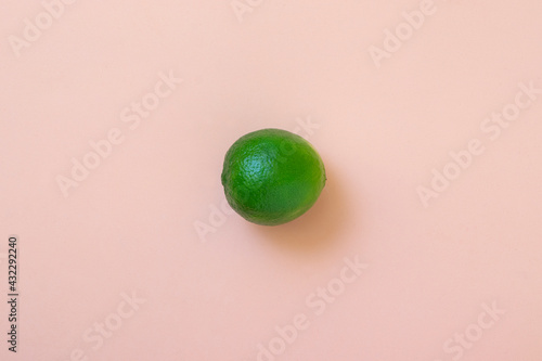Fresh and natural lime on light pink background