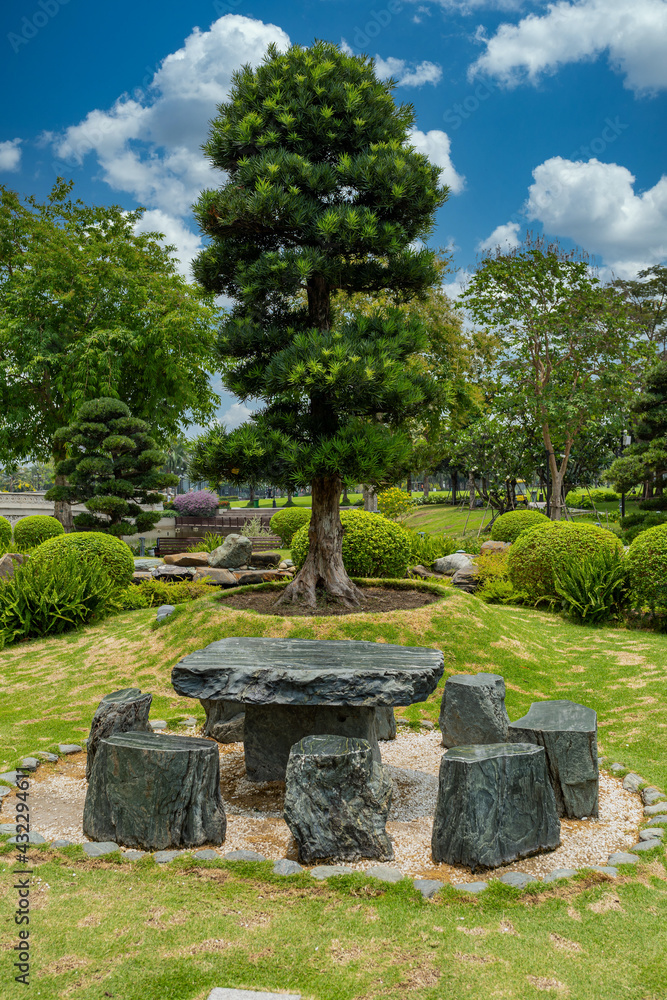 Japanese garden with yew tree bonsai and stone table and chairs