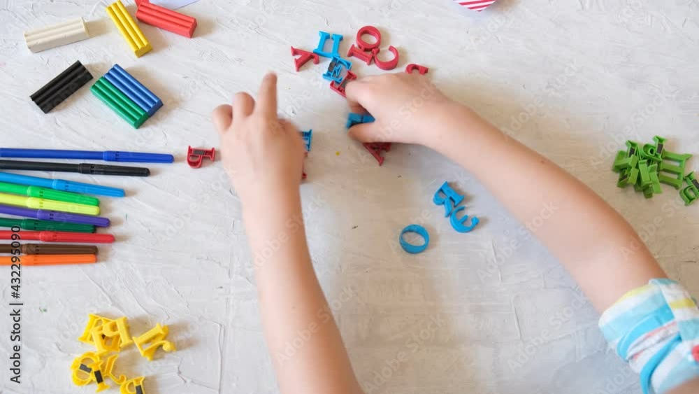 Toddler playing with colorful magnets in shape russian alphabet , Cyrillic alphabet, Home Education game. Educational and entertaining with children
Toddler playing with colorful magnets in shape russian alphabet , Cyrillic alphabet, Home Education game. Educational and entertaining with children
