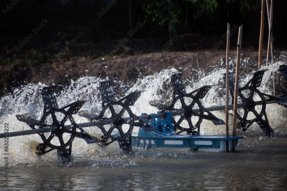 A water turbine used to rotate the water in the aquaculture pond with a ...