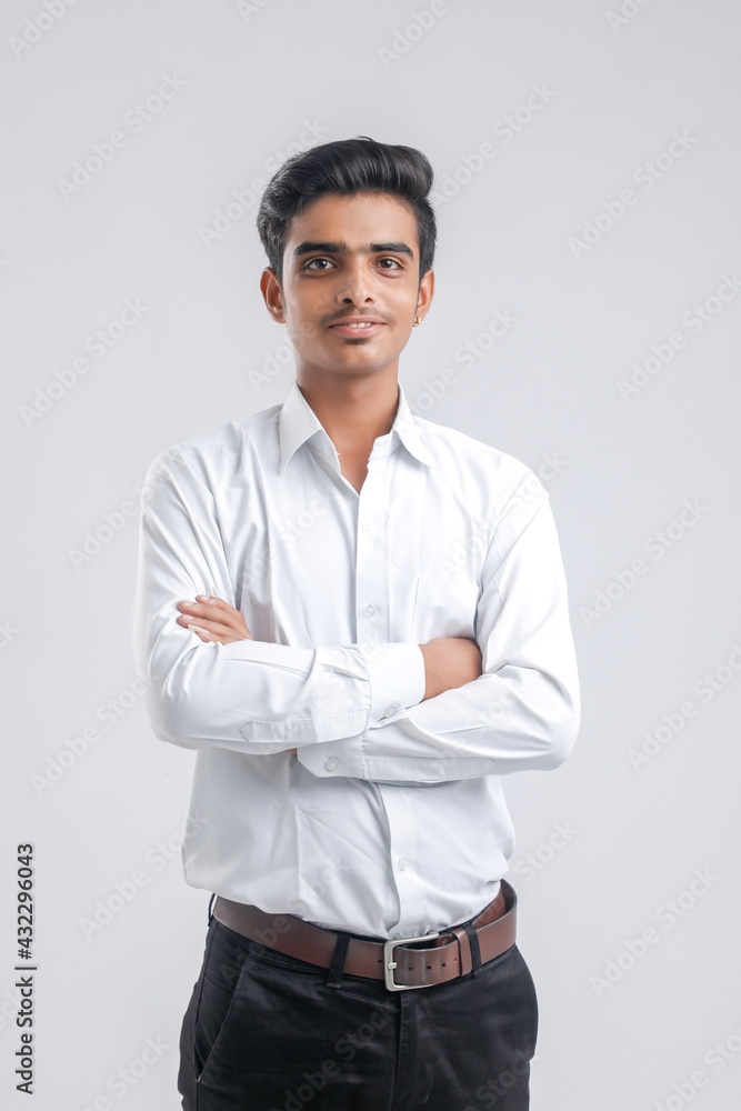 Young indian boy in white shirt over white background Young indian boy in white shirt over white background