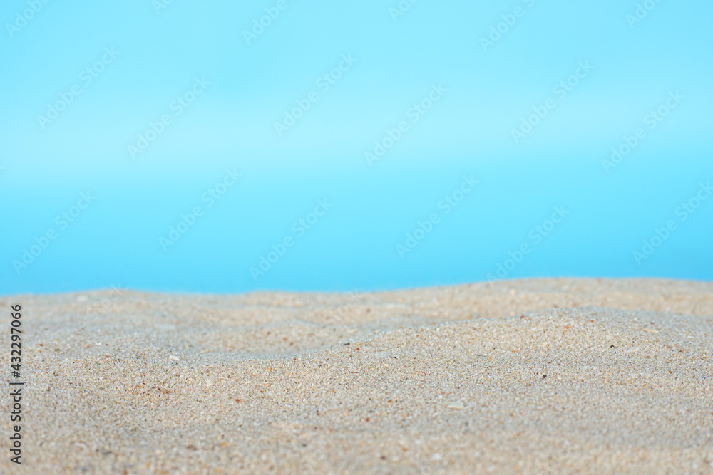 Sea beach sand texture on blue background with selective focus. Summer background concept. Sea beach sand texture on blue background with selective focus. Summer background concept.